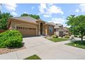 Charming single-story home with a two-car garage, landscaped yard and sidewalk at 11645 Colony Loop, Parker, CO 80138
