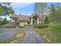 Stylish home with a tiled roof and a paved driveway leading up to the front door at 787 W Meadow Rd, Evergreen, CO 80439