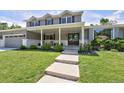 Charming two-story home with manicured lawn, covered porch, and inviting entrance at 3843 S Quince St, Denver, CO 80237