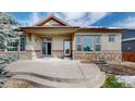 The concrete patio offers a cozy outdoor living space with stone accents at 6544 S Millbrook Way, Aurora, CO 80016