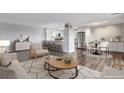 Bright living room featuring hardwood floors, an open kitchen with a breakfast bar, and a comfortable seating area at 460 S Marion Pkwy # 1351, Denver, CO 80209
