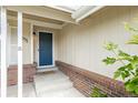 View of the front porch and the front door of the house with brick siding at 551 Snowy Owl Pl, Highlands Ranch, CO 80126