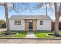 Charming home with freshly cut grass, walkway, a black door and lovely trimmed trees at 1130 Orchard St, Golden, CO 80401