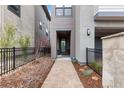 Paver walkway leading to front door with neutral exterior paint, black metal fence and xeriscaping at 10113 Bellwether Ln, Lone Tree, CO 80124