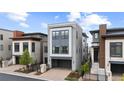 Contemporary style home showcasing a three-story facade with a gray two-car garage at 10113 Bellwether Ln, Lone Tree, CO 80124