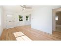 Spacious and well-lit living area with beautiful hardwood floors and access to the bathroom at 1151 Xanthia St, Denver, CO 80220