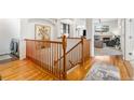 Elegant wooden staircase leading to upper level with hardwood floors at 20697 E Lake Ave, Centennial, CO 80016