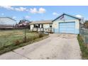 Exterior showing a garage with an American flag, a small deck, and a chain-link fence at 445 S Depew St, Lakewood, CO 80226