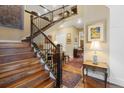 Elegant foyer features a staircase with wood treads, iron spindles, and views into formal living spaces at 1995 Wingfeather Ln, Castle Rock, CO 80108