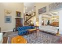 The living room has high ceilings, walls painted in warm, neutral colors, and a staircase leading to the second floor at 1995 Wingfeather Ln, Castle Rock, CO 80108