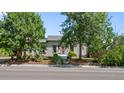 House with mature trees and a well-maintained lawn at 2311 W 46Th Ave, Denver, CO 80211