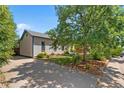 House with a driveway, mature trees, and a neatly landscaped yard at 2311 W 46Th Ave, Denver, CO 80211