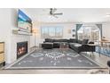 Comfortable living room featuring a modern fireplace, stylish decor, and sliding glass doors to the backyard at 126 S Vandriver Way, Aurora, CO 80018