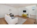 Bright and modern living room featuring wood floors, stylish decor, and ample natural light at 3389 Cranston Cir # 3389, Highlands Ranch, CO 80126