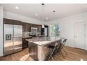 Modern kitchen features stainless appliances, granite counters, and an island with bar seating at 3389 Cranston Cir, Highlands Ranch, CO 80126