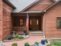 Charming front porch with brick pathway and flower pots leads to a wooden door at 28465 Cragmont Dr, Evergreen, CO 80439