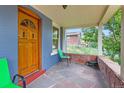 Inviting front porch with stone flooring, comfortable seating and charming view at 3547 Osage St, Denver, CO 80211