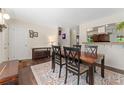 Cozy dining room, complete with a dining table, bench, console, and decorative artwork at 980 S Nile Way, Aurora, CO 80012