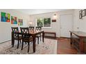 Bright dining room with a decorative rug, wooden table, and a large window with natural light at 980 S Nile Way, Aurora, CO 80012