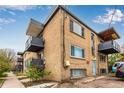 Rear brick elevation featuring balconies and residential parking at 200 N Sherman St # 7, Denver, CO 80203