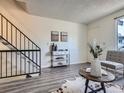 Inviting entryway featuring stylish console table, modern decor, and staircase access to the upper level at 17681 E Loyola Dr # E, Aurora, CO 80013