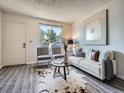 Comfortable living room features contemporary decor, cozy seating, and a sunlit window for natural light at 17681 E Loyola Dr # E, Aurora, CO 80013