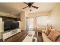 Inviting living room featuring hardwood floors, comfortable seating, and a large TV at 5732 S Addison Way # E, Aurora, CO 80016