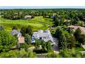 Expansive aerial view showcases the property's prime location on a lush golf course with mature trees at 96 Glenmoor Ln, Cherry Hills Village, CO 80113