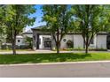 Beautiful home featuring well-maintained landscaping and a sophisticated gated entrance enhancing its curb appeal at 96 Glenmoor Ln, Cherry Hills Village, CO 80113