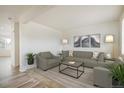 Bright living room featuring neutral tones, stylish decor, and comfortable seating arrangements at 9283 Sedalia St, Commerce City, CO 80022