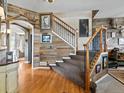 Beautiful staircase with wooden railing and custom wood accent wall leading to the upper level at 10273 Salida St, Commerce City, CO 80022