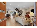 An inviting living room with an open floor plan, modern staircase, and stylish decor at 613 Iowa St, Golden, CO 80403
