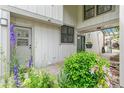 Inviting entryway with brick pavers and garden featuring colorful flowers and greenery at 8474 E Otero Cir, Centennial, CO 80112