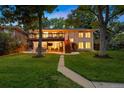 Spacious backyard with a two-level deck, lush lawn, and mature trees at 13693 W Utah Cir, Lakewood, CO 80228