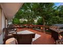 Relax on the deck with a grill, outdoor seating, and a view of the yard at 13693 W Utah Cir, Lakewood, CO 80228