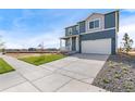 Two-story home with gray siding, white trim, and a two-car garage at 2245 Base St, Fort Lupton, CO 80621