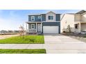 Two-story house with gray siding, white trim, and a two-car garage at 2245 Base St, Fort Lupton, CO 80621