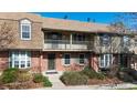 Charming townhouse with a brick facade, balcony, and a well-maintained front garden at 8752 E Amherst Dr # D, Denver, CO 80231