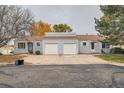 Low angle view of two single-story homes with a shared driveway, showing garages at 16179 E Rice Pl # B, Aurora, CO 80015