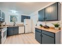 View of a galley-style kitchen with wood countertops and modern appliances at 16179 E Rice Pl # B, Aurora, CO 80015