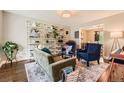Bright living room with stylish decor, shelving, and a view into the dining room at 7708 S Krameria Ct, Centennial, CO 80112