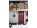 Close up of home with snow, stylish front door and wood railings at 11710 Spruce Canyon Cir, Golden, CO 80403
