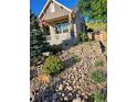 Attractive front yard with rock features, lush plants, and a charming home with an American flag at 1815 Avery Way, Castle Rock, CO 80109