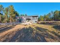 Modern home with a three-car garage and a flag on a large lot at 1580 Crystal Way, Franktown, CO 80116