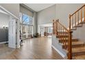 Bright living room with hardwood floors, a soaring ceiling, and large windows at 16123 Quarry Hill Dr, Parker, CO 80134