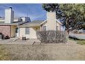 Townhouse exterior with a quaint entrance and well-kept lawn at 8300 S Upham Way, Littleton, CO 80128