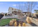 Spacious backyard with a well-manicured lawn, pergola with BBQ, and a serene outdoor setting at 7899 S Country Club Pkwy, Aurora, CO 80016