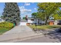 Beautiful home with a spacious driveway, mature trees, and a well-maintained lawn at 848 S 13Th Ave, Brighton, CO 80601