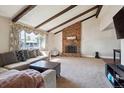 Inviting living room with vaulted ceilings, exposed beams, and a cozy brick fireplace at 848 S 13Th Ave, Brighton, CO 80601
