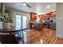 Updated kitchen featuring stainless steel appliances, granite countertops, and rich hardwood flooring at 4673 S Lowell Blvd, Denver, CO 80236